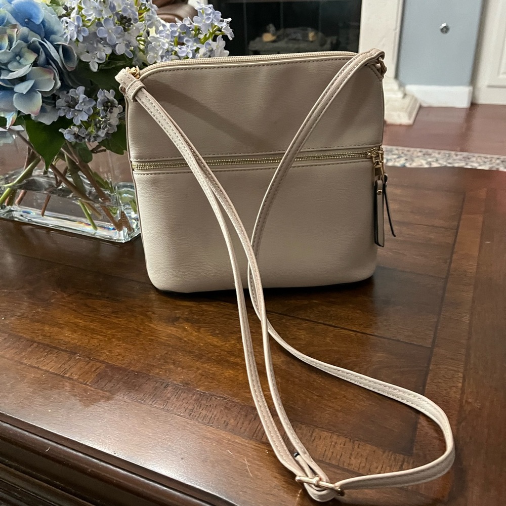 Brand new, light pink or cream , never used crossbody bag.